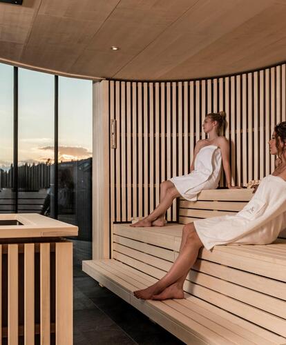 Two women sitting in the sauna