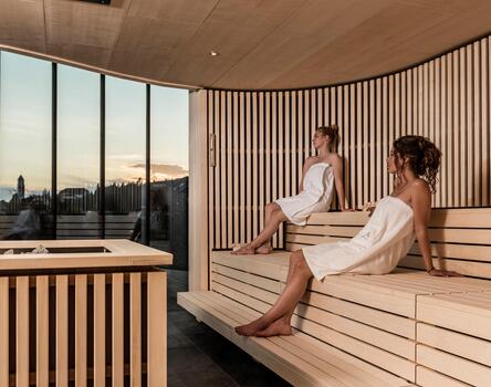Two women sitting in the sauna