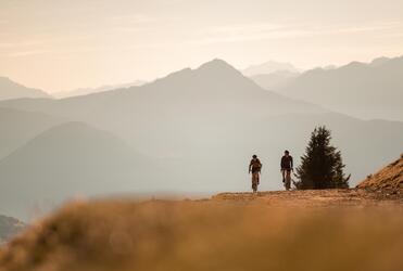Due ciclisti pedalano su una strada sterrata in montagna