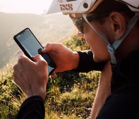 Un mountain biker guarda il suo smartphone