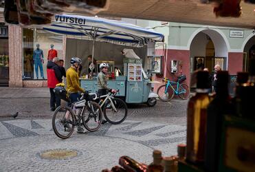 Two cyclists are in the old town of Merano